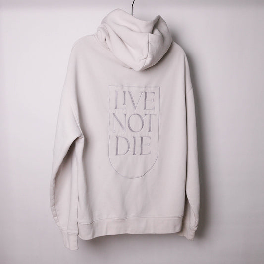 LIVE NOT DIE HOODIE AGAINS A WHITE BACKDROP