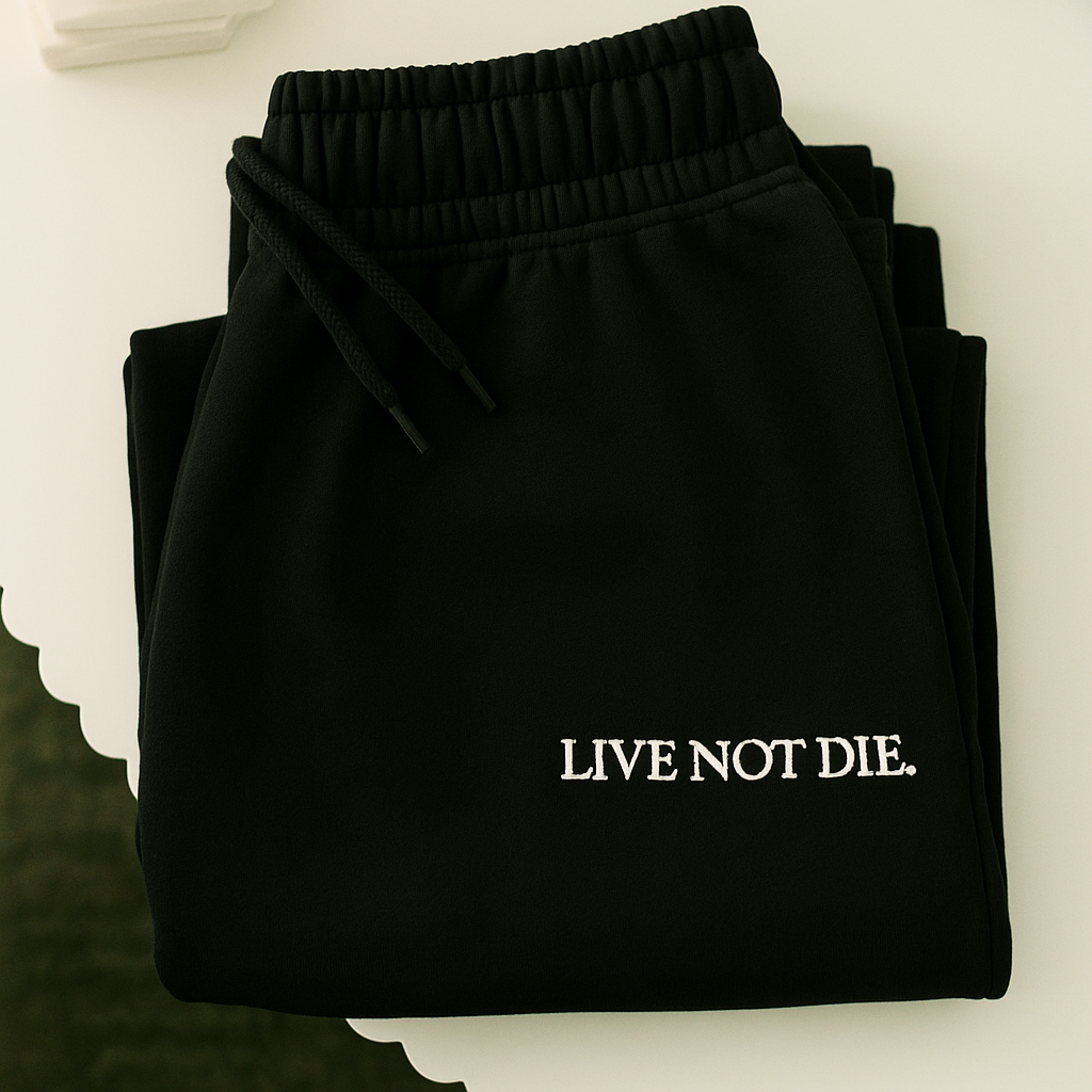 A product shot of the live not die trackpants