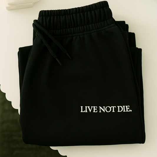 A product shot of the live not die trackpants