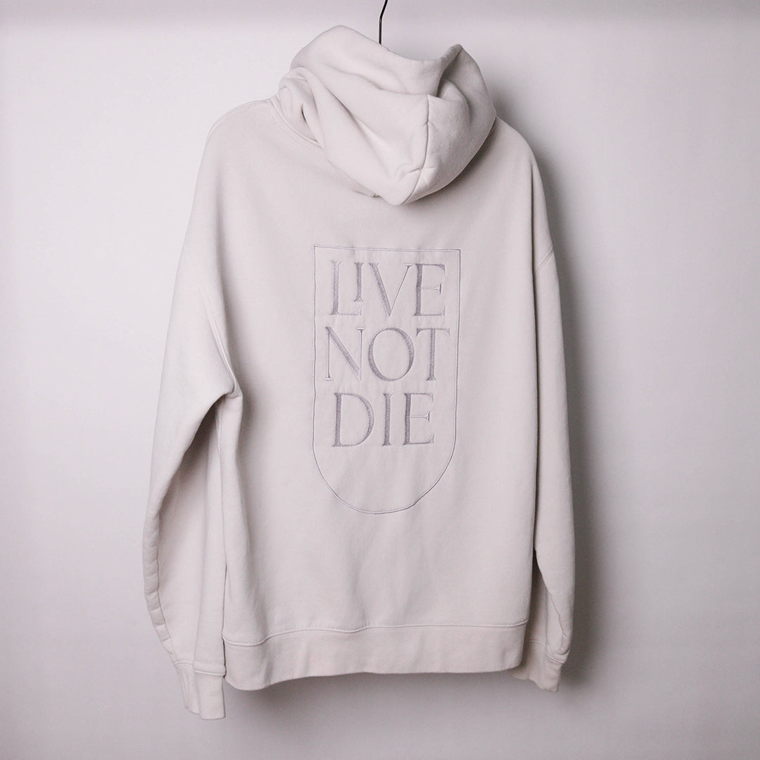 LIVE NOT DIE HOODIE AGAINS A WHITE BACKDROP