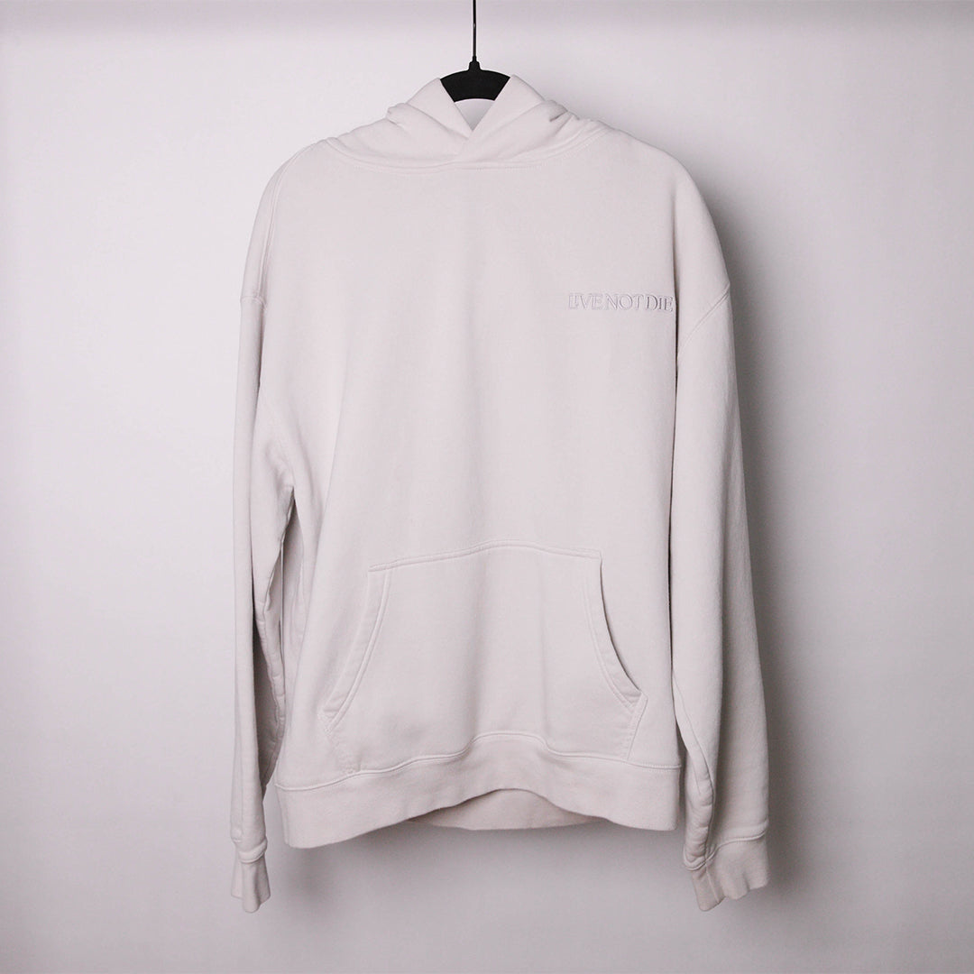 LIVE NOT DIE HOODIE AGAINS A WHITE BACKDROP