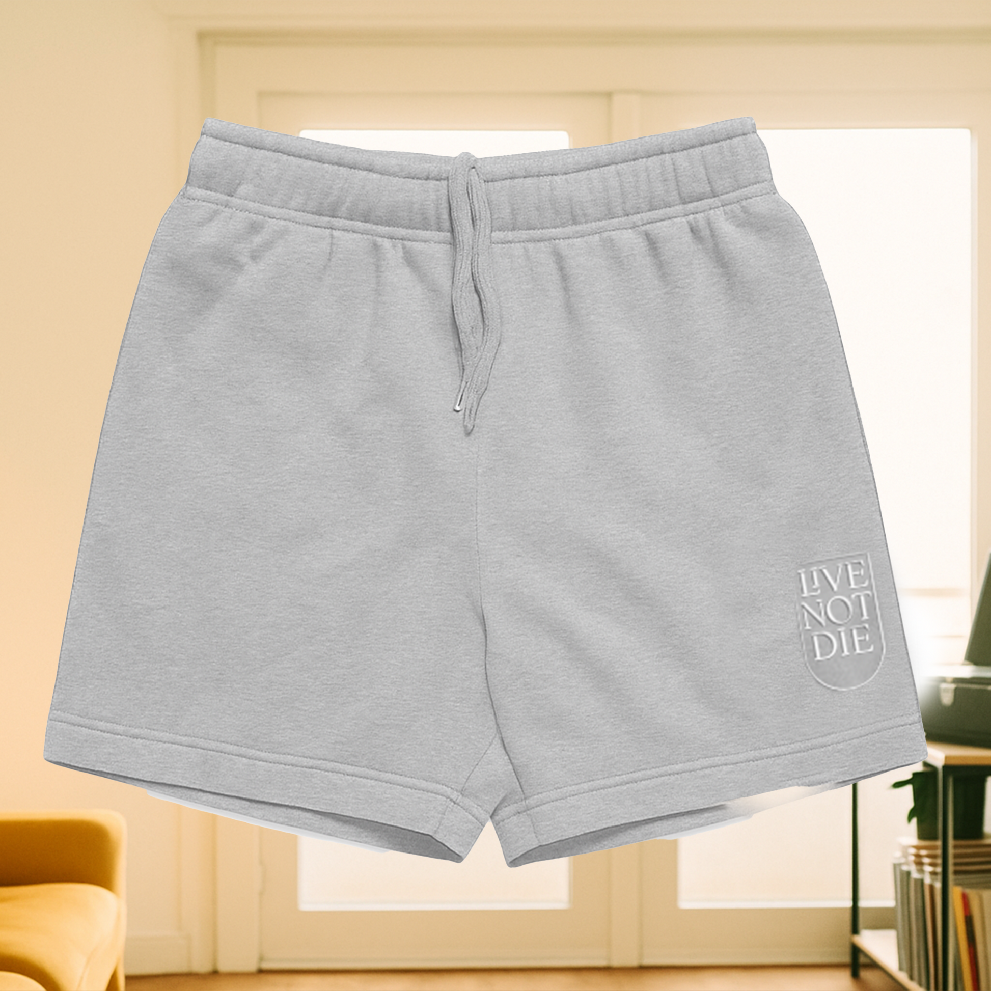 Product image of Live Not Die track shorts in a living room setting in gray