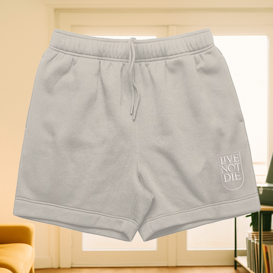 Product image of Live Not Die track shorts in a living room setting in bone color