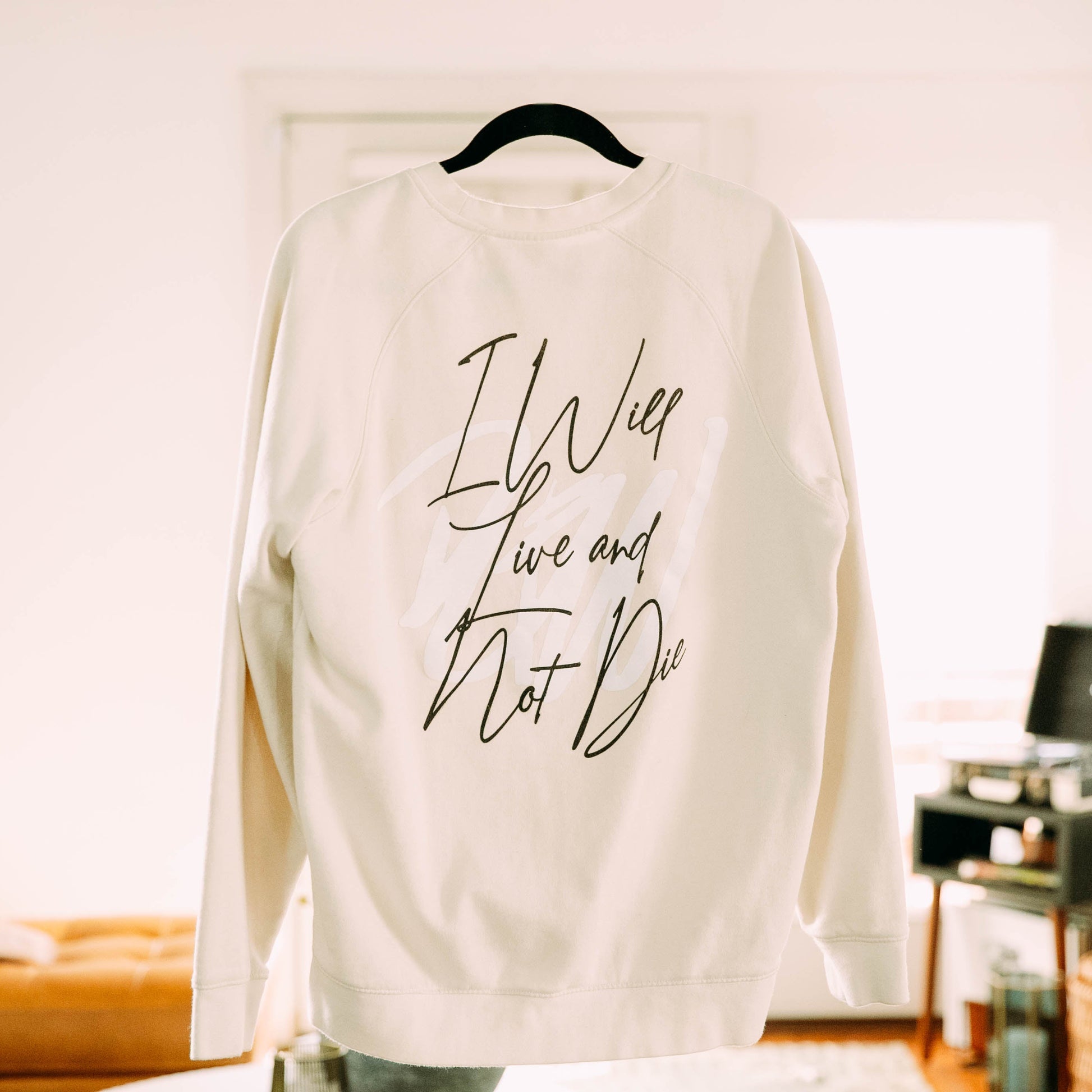I Will Live Not Sweatshirt in a living room