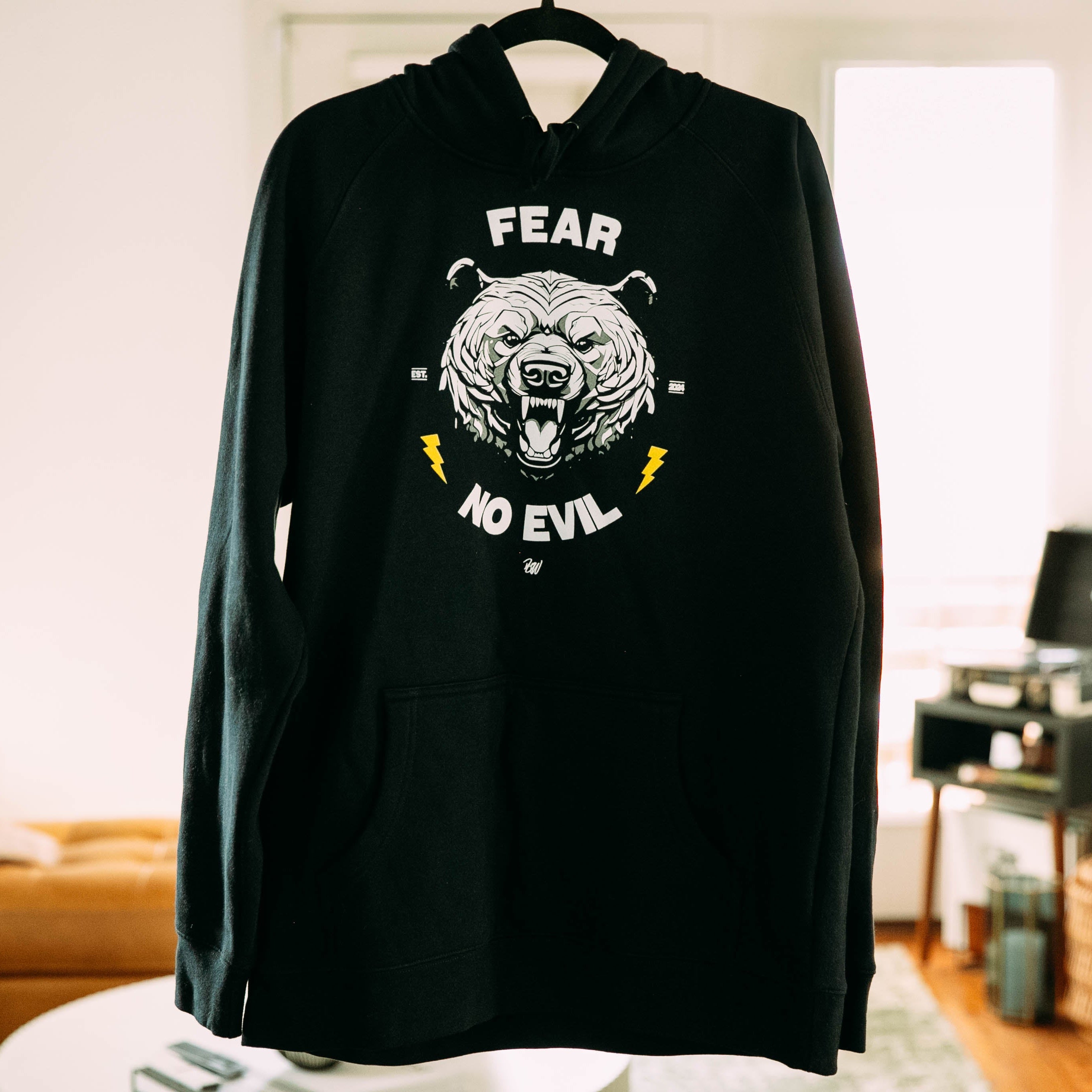 The fear no evil hoodie bear hoodie in a living room
