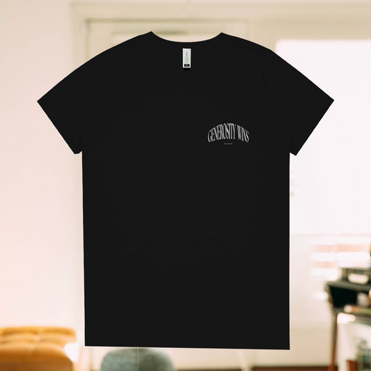 A Live Not Die product photo of the generosity wins t shirt in black in a living room